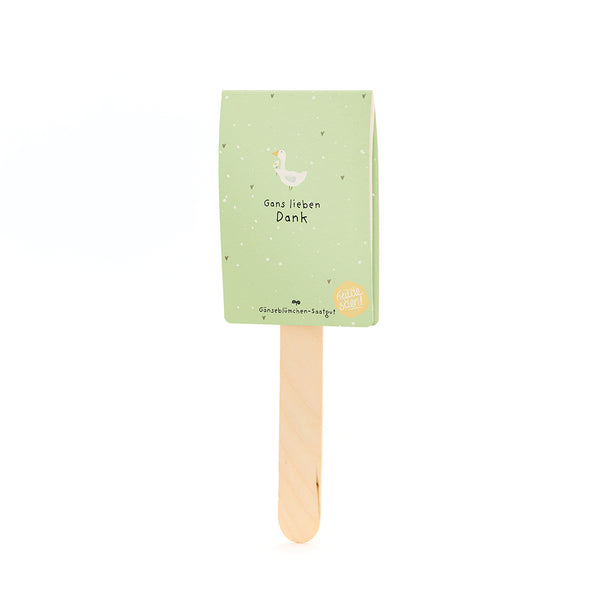 Une carte verte avec une illustration d’oie et le texte « Merci beaucoup » sur un bâton en bois.
