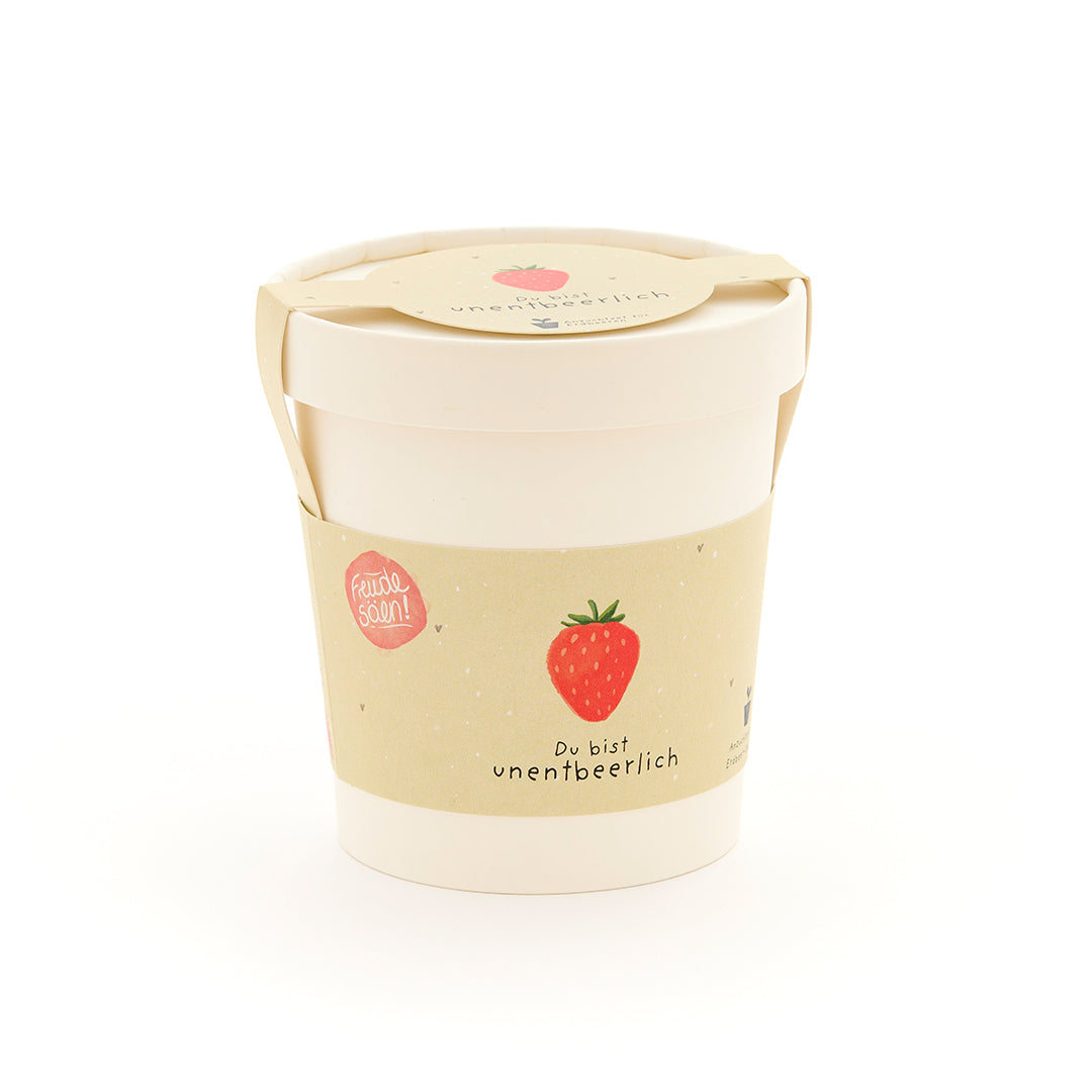 Emballage blanc avec une illustration de fraise et l’inscription « Vous êtes indispensable ».