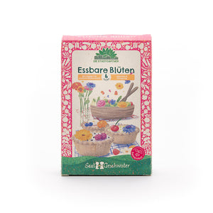 Pack de graines "Fleurs comestibles" de Saatgeschwister, conçu de manière colorée avec des illustrations de fleurs comestibles et de pâtisseries.