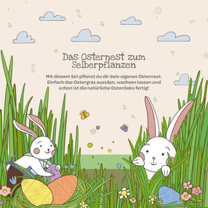 Illustration avec deux lapins de Pâques blancs, des œufs de Pâques, de l'herbe haute, des fleurs, des papillons et des nuages ; le texte explique un kit pour planter un nid de Pâques.