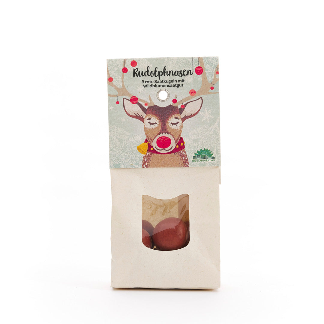 Sac en papier avec un imprimé de renne et le texte « Rudolph Noses – 8 boules de graines rouges avec graines de fleurs sauvages », avec une fenêtre de visualisation contenant des boules de graines rouges en dessous.