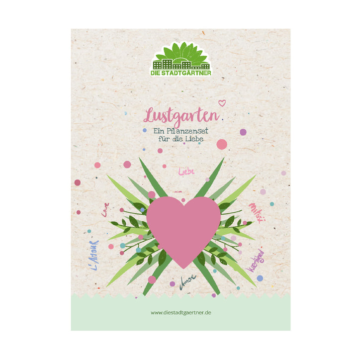 Emballage pour un ensemble de plantes avec un grand cœur rose, des feuilles vertes et l'inscription « Lustgarten – Un ensemble de plantes pour l'amour » sur fond beige.
