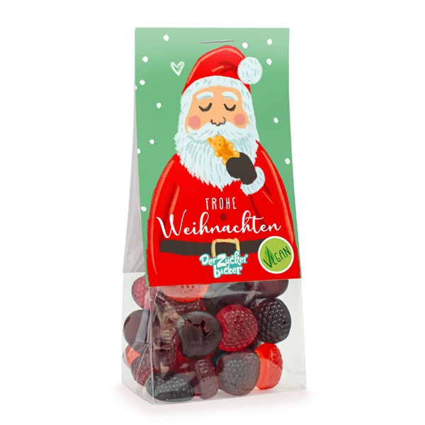 Emballage avec des bonbons de Noël végétaliens et une image du Père Noël mangeant un biscuit avec les mots « Joyeux Noël ».