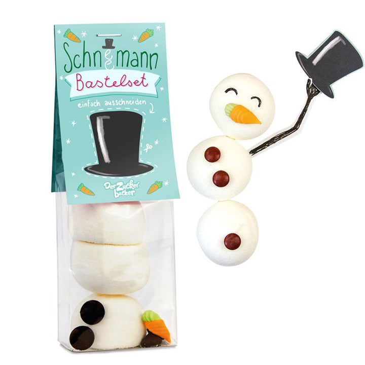 Un kit de bricolage pour un bonhomme de neige avec des morceaux de sucre et un emballage qui sert de modèle.