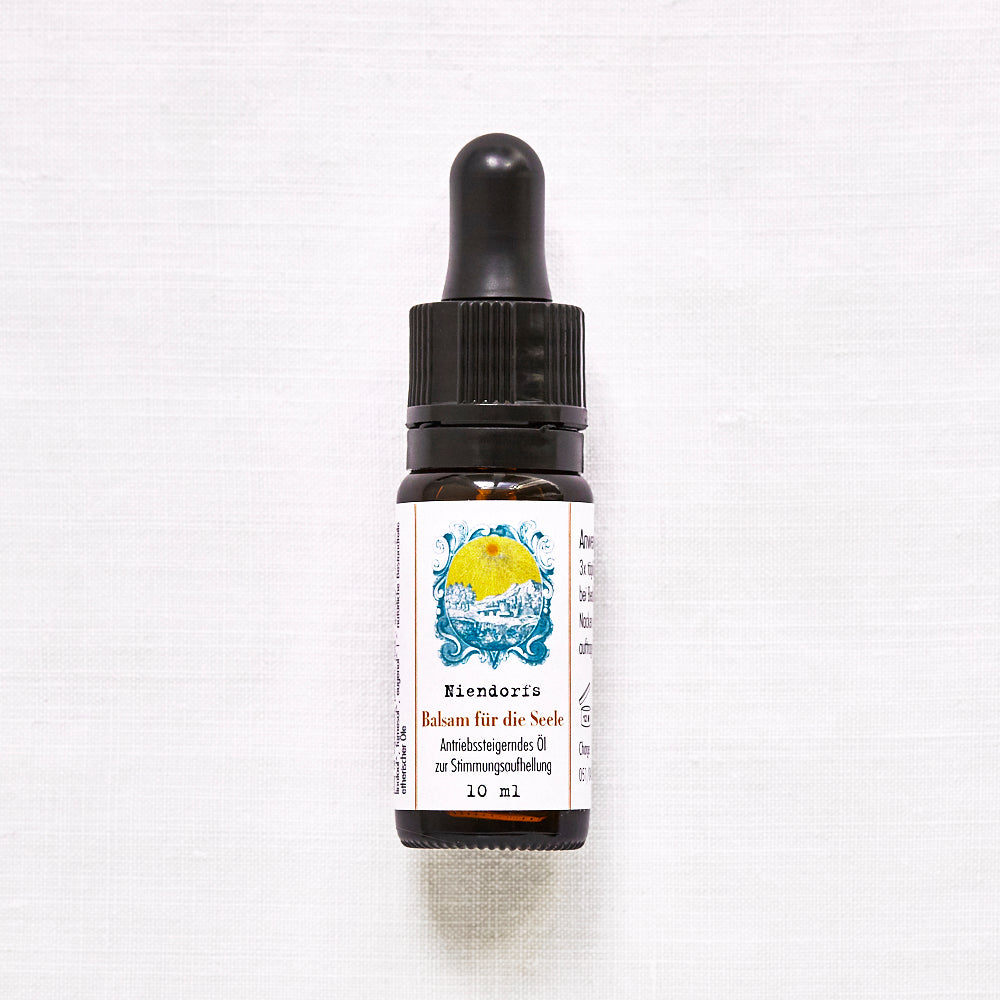 Flacon avec pipette sur fond clair, étiquette indiquant « Baume pour l'âme de Niendorf, huile anti-stress pour égayer l'humeur, 10 ml ».
