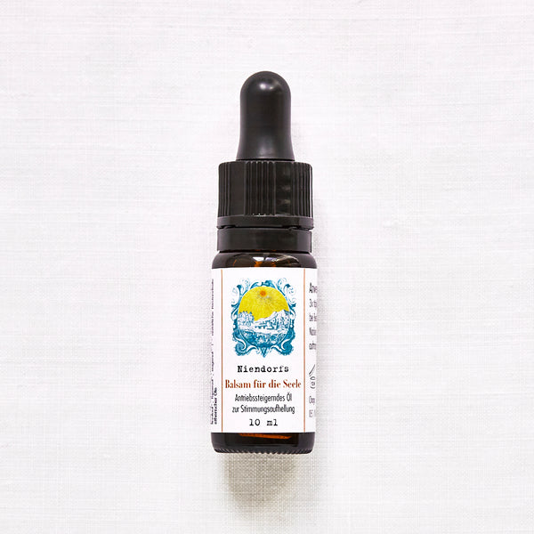Flacon avec pipette sur fond clair, étiquette indiquant « Baume pour l'âme de Niendorf, huile anti-stress pour égayer l'humeur, 10 ml ».