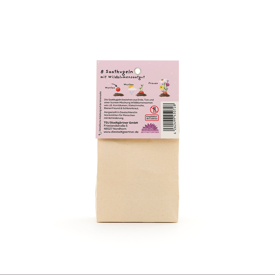Sac en papier brun avec une étiquette en allemand décrivant « 8 boules de graines avec des graines de fleurs sauvages ».