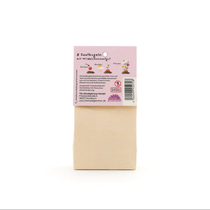 Sac en papier brun avec une étiquette en allemand décrivant « 8 boules de graines avec des graines de fleurs sauvages ».