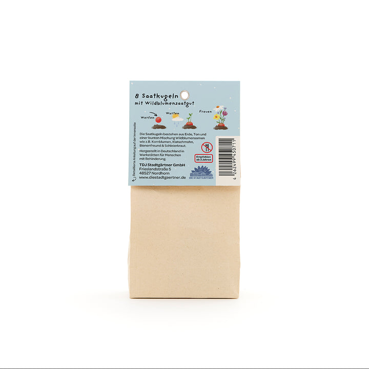 Sac en papier avec une étiquette bleue au dos décrivant « 8 boules de graines avec graines de fleurs sauvages » et contenant des illustrations et des informations textuelles.