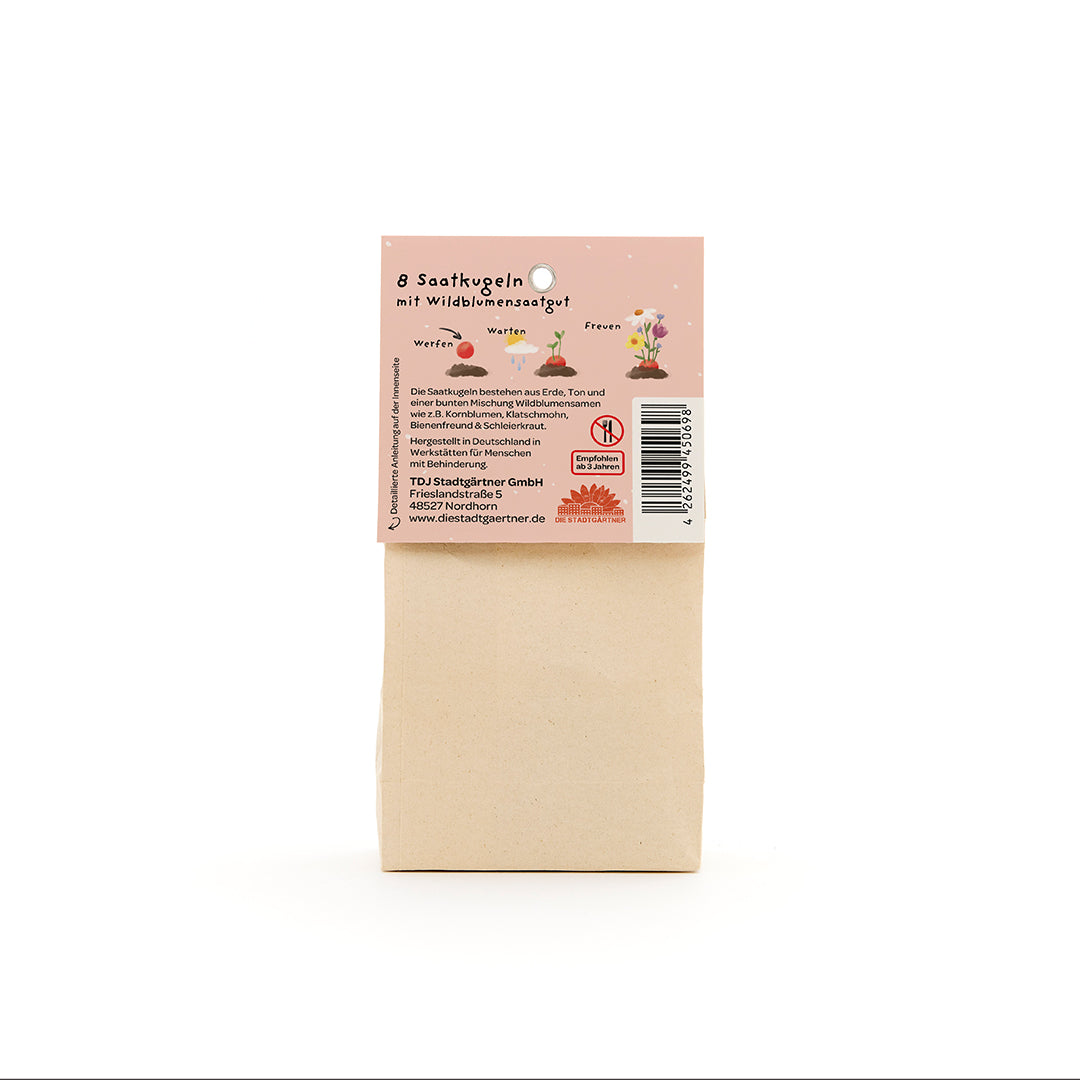 Sac en papier avec une étiquette décrivant 8 boules de graines de fleurs sauvages, ainsi que des informations sur l'application et les instructions du fabricant en allemand.