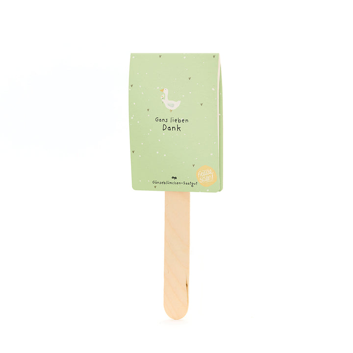 Une carte verte avec une illustration d’oie et le texte « Merci beaucoup » sur un bâton en bois.