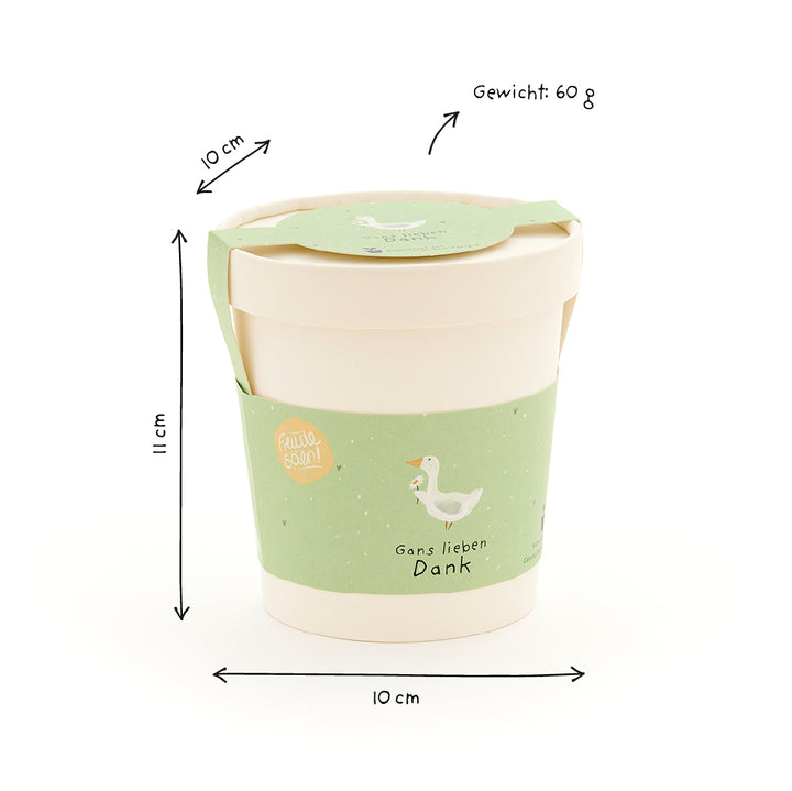 Mug avec une étiquette verte, une oie dessinée et l'inscription "Gans lieben Dank" (Merci beaucoup), à côté les dimensions et le poids (10 cm x 10 cm x 11 cm, 60 g).