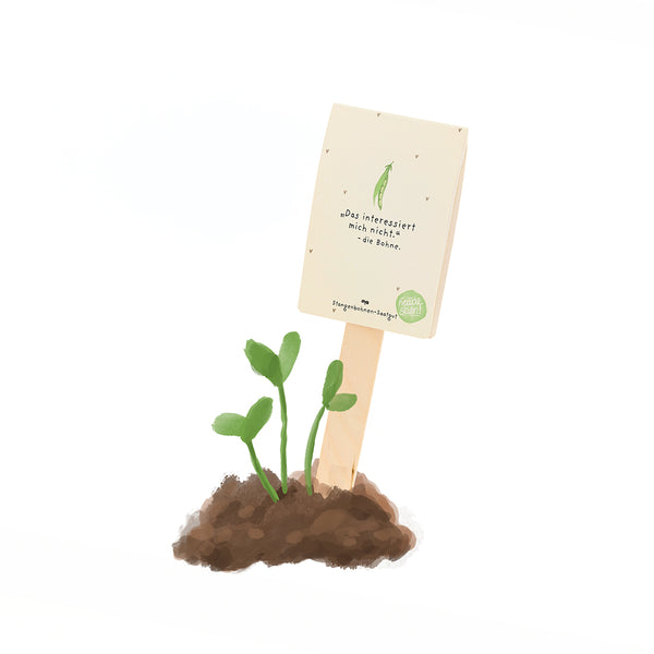 Jeune plante verte poussant hors du sol avec un panneau sur lequel on peut lire en allemand : « Je ne suis pas intéressé par le haricot. »