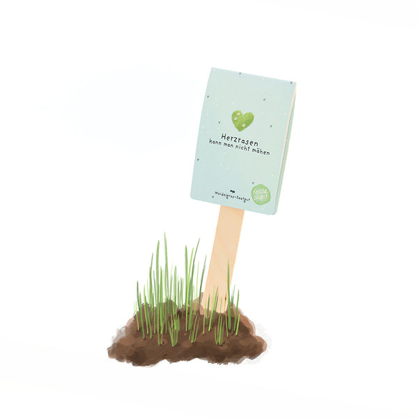 Un petit panneau indiquant « On ne peut pas tondre un cœur qui bat » est planté dans le sol avec quelques brins d'herbe.