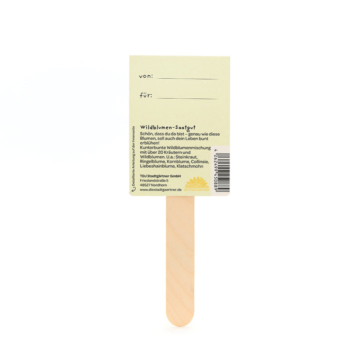 Dos d'un bâtonnet de graines de fleurs sauvages en bois avec une étiquette jaune et une description en allemand.