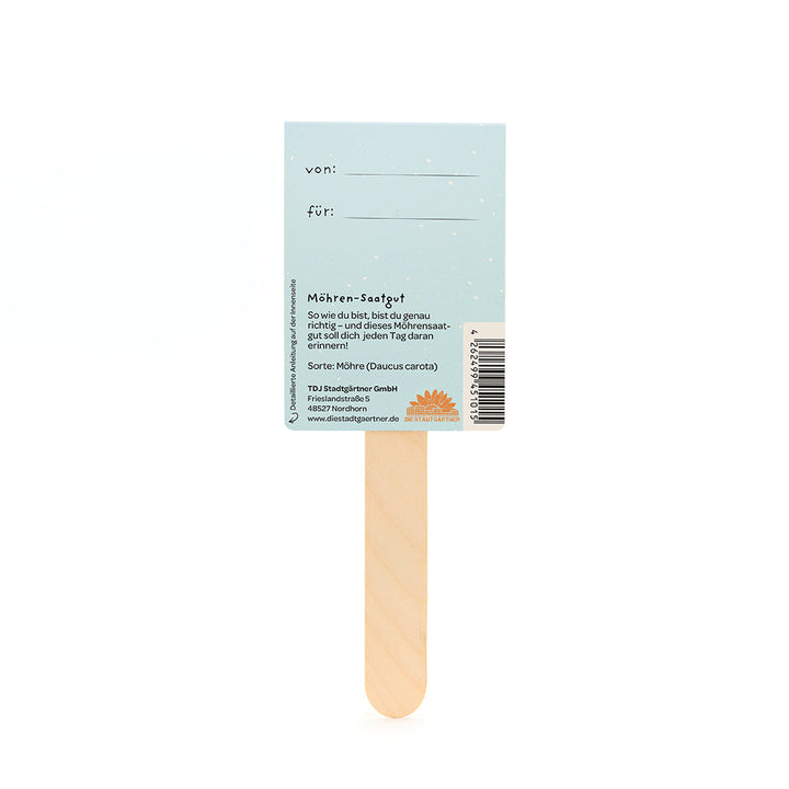 Dos d'une étiquette de graines de carottes sur un bâton en bois avec des champs pour « de » et « pour » et des informations sur les graines de carottes en allemand.
