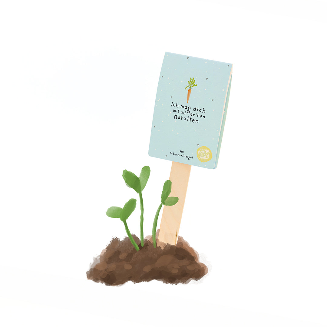 Une petite plante verte pousse dans le sol, avec un panneau à côté sur lequel on peut lire : « Je t'aime avec toutes tes carottes. »