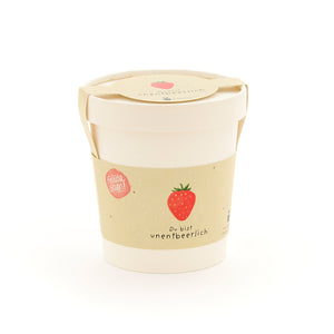 Emballage blanc avec une illustration de fraise et l’inscription « Vous êtes indispensable ».
