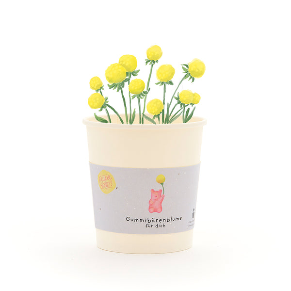 Tasse avec des fleurs d'oursons en gélatine jaunes et une étiquette indiquant « Fleur d'oursons en gélatine pour vous ».