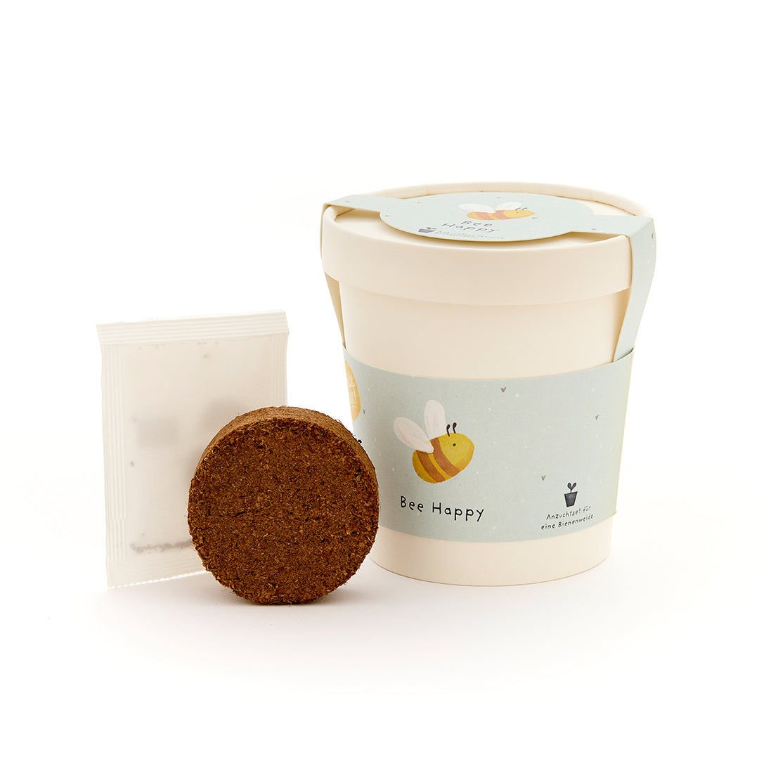 Kit de plantation avec tablette de germination ronde, sachet de graines et une tasse avec motif d'abeille et inscription "Bee Happy".
