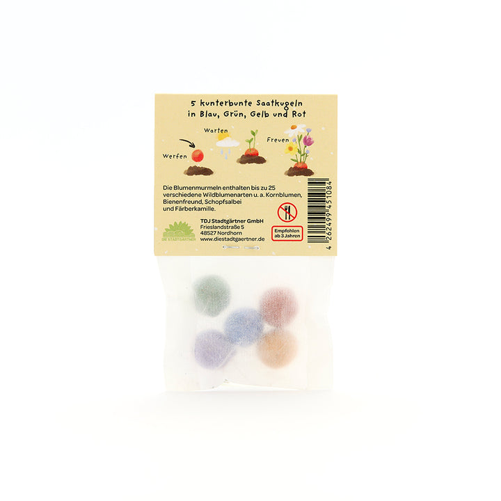 Cinq boules de graines colorées dans un emballage transparent avec des instructions et des illustrations en allemand au dos.