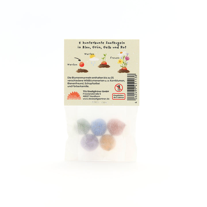 Cinq boules de graines colorées dans un emballage transparent avec des instructions illustrées et des descriptions en allemand.