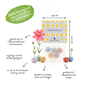 Un sac de boules de graines colorées, étiqueté avec des informations en allemand sur la taille, les ingrédients, la production biologique et l'adéquation aux enfants, ainsi que quelques fleurs en fleurs et un marquage vert indiquant « 100 % biologique et dure au moins 2 ans ».