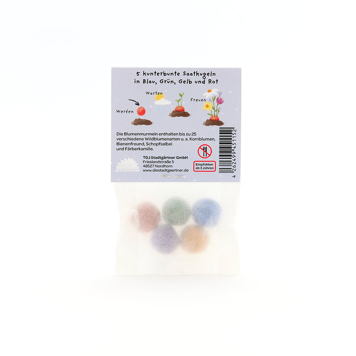 Cinq boules de graines colorées en bleu, vert, jaune et rouge dans un emballage avec description et instructions en allemand.