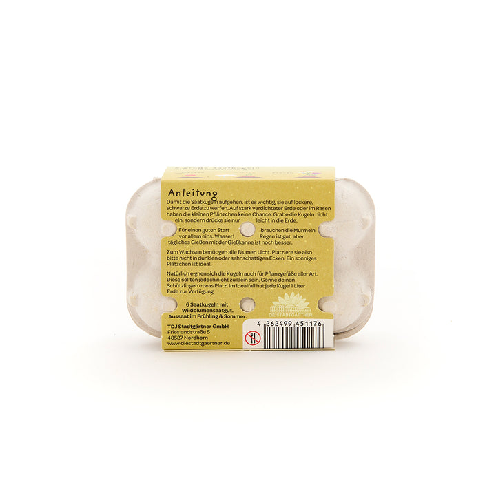 Dos d'une petite boîte à œufs avec instructions jointes pour semer des graines, code-barres et informations sur le fabricant en allemand.