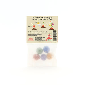 Sachet contenant cinq boules de graines colorées en bleu, vert, jaune et rouge, emballage avec description et illustrations en allemand.