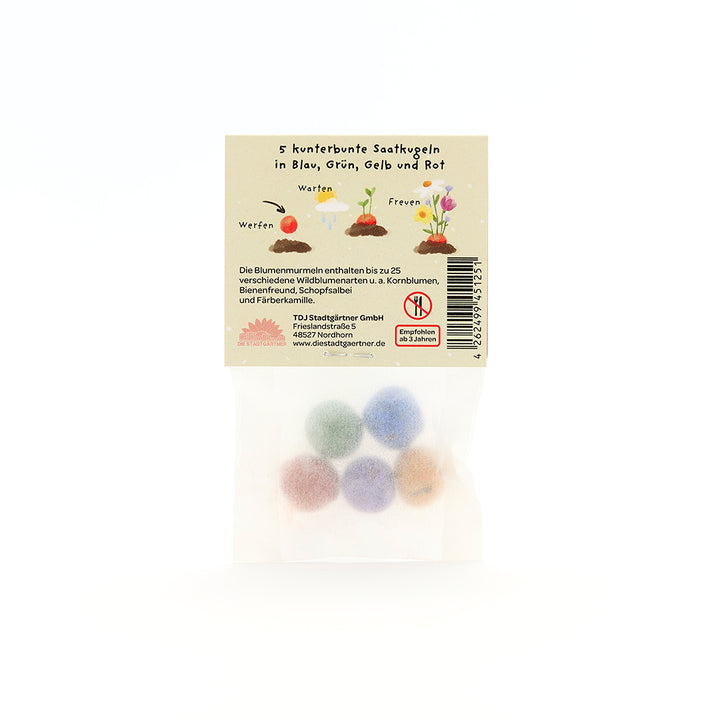 Sachet contenant cinq boules de graines colorées en bleu, vert, jaune et rouge, emballage avec description et illustrations en allemand.
