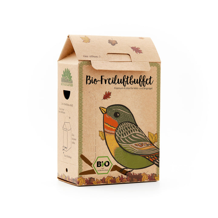 Emballage en carton avec un dessin d'oiseau coloré et l'inscription « Buffet Bio en Plein Air », nourriture haut de gamme pour oiseaux sauvages et chanteurs.