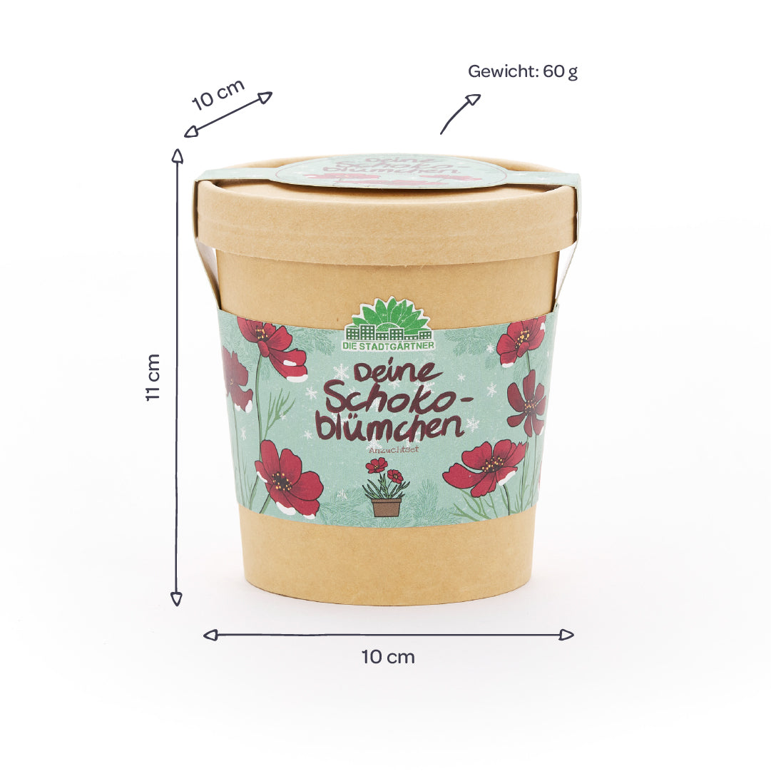 Gobelet en papier avec motif floral et inscription « Deine Schokoblümchen », à côté des dimensions (10 cm de diamètre, 11 cm de hauteur) et du poids (60 g) indiqués en allemand.
