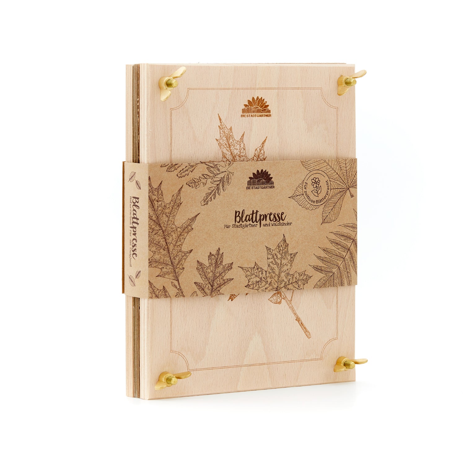 Presse à feuilles en bois avec gravures botaniques et bande de papier brun, sur laquelle sont imprimés des motifs de feuilles et l'inscription « Leaf Press ».