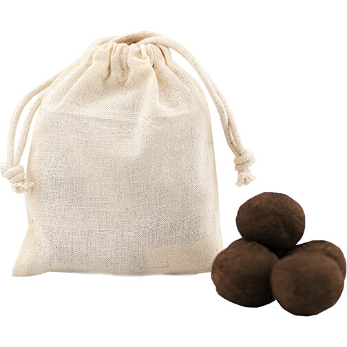 Sac à cordon en lin à côté de truffes au chocolat sur fond blanc