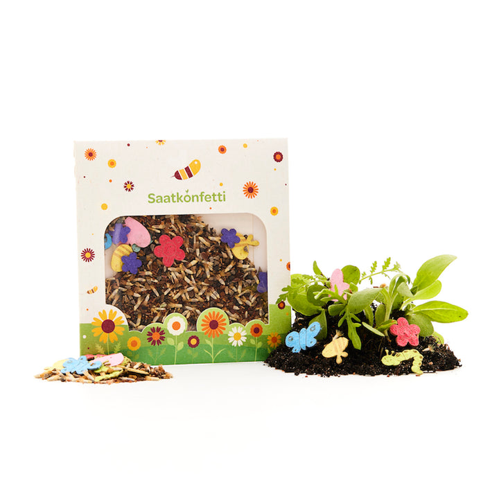 Un paquet de confettis de graines avec des graines de fleurs décoratives et des confettis en papier colorés en forme de fleurs et de papillons, ainsi que des plantes poussant dans le sol.