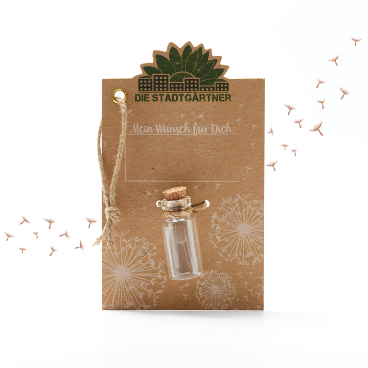 Carte marron avec l'inscription « Les Jardiniers de la Ville », une petite bouteille en verre et des pissenlits illustrés.