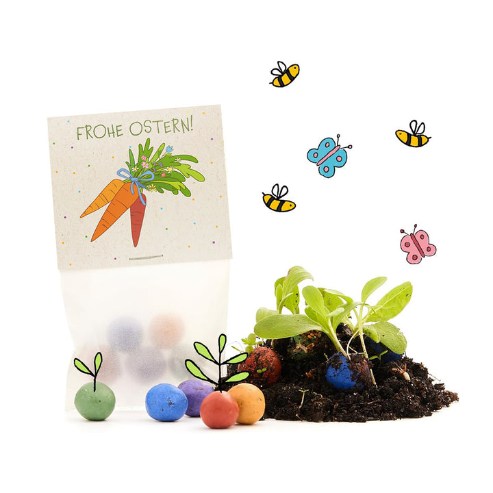Cadeau de Pâques avec un emballage coloré « Joyeuses Pâques », des boules de graines de différentes couleurs et des plantes qui poussent sur le sol, entourées d'abeilles et de papillons dessinés.