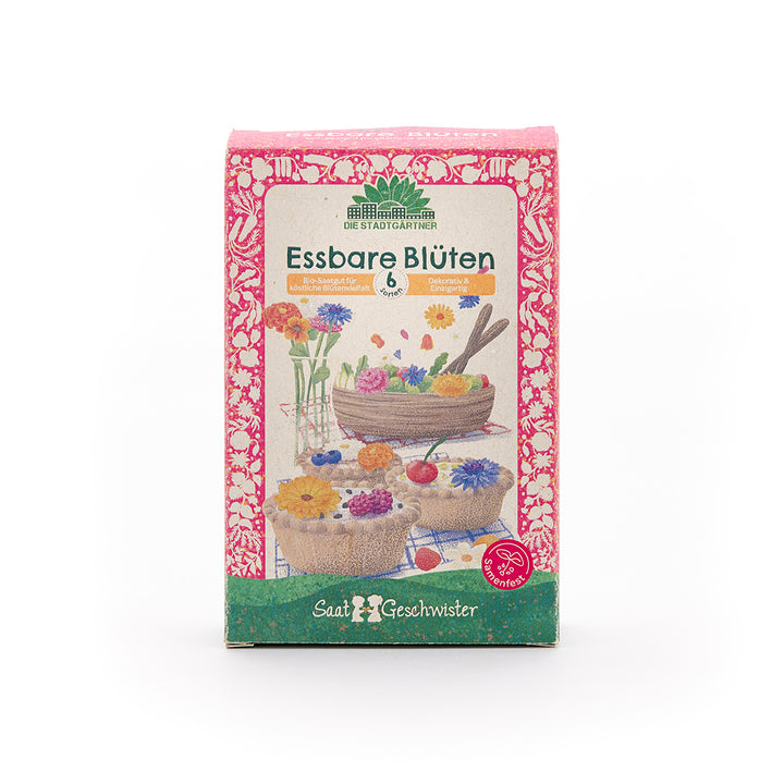 Pack de graines "Fleurs comestibles" de Saatgeschwister, conçu de manière colorée avec des illustrations de fleurs comestibles et de pâtisseries.