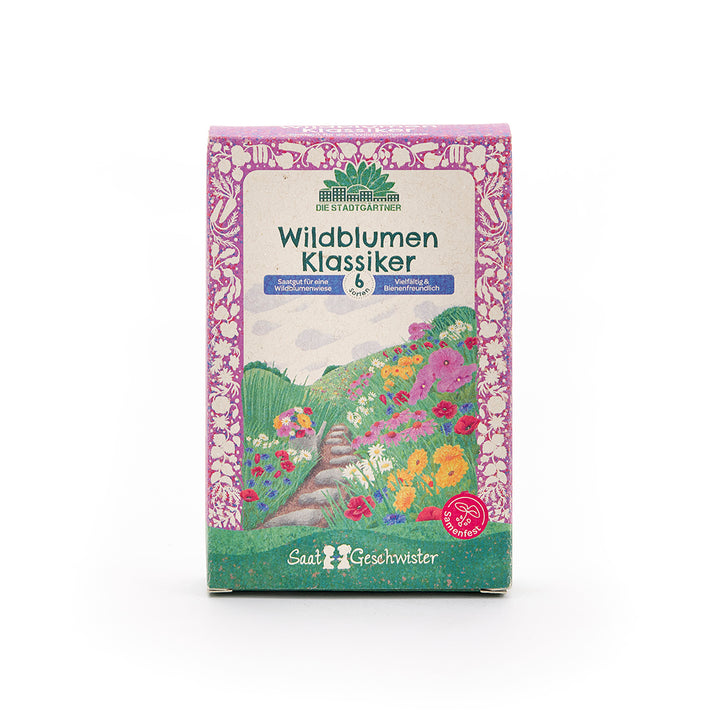 Emballage étiqueté « Wildflower Classics » par Die Stadtgärtner, avec des illustrations de fleurs colorées et un cadre violet.