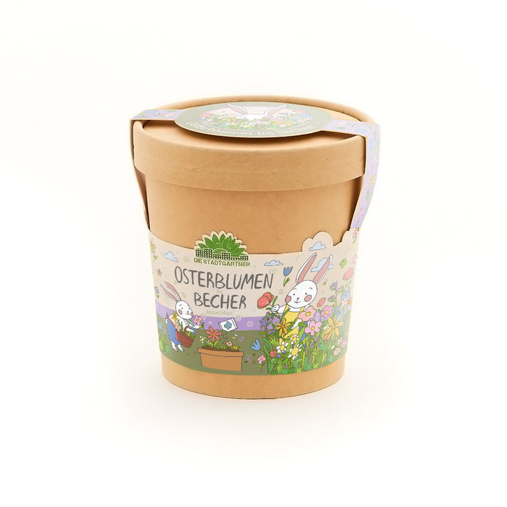 Pot de fleurs marron avec des décorations de Pâques colorées et l'inscription « Easter Flowers Cup », illustrée de fleurs et d'un lapin.