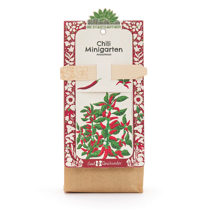 Kit de culture de mini-jardin de piments de Die Stadtgärtner avec motif de plantes rouges et vertes sur l'emballage.