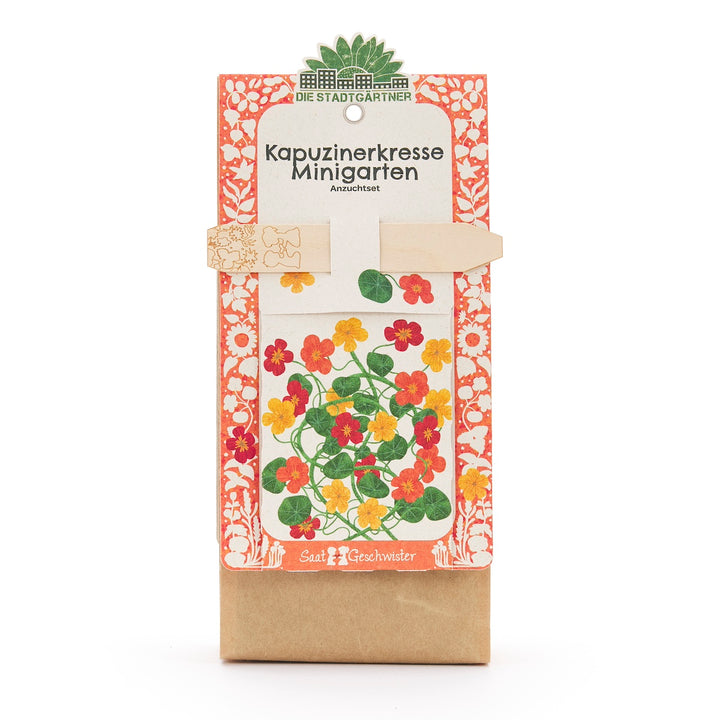 Emballage d'un kit de culture de mini jardin de capucines avec motif de fleurs colorées et bordure décorative.