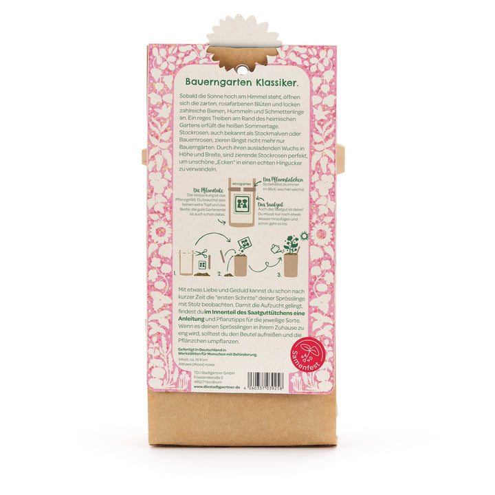 Dos d'un sachet de graines de fleurs, description et instructions en allemand, motif floral rose, un logo rouge du Seed Festival en bas.