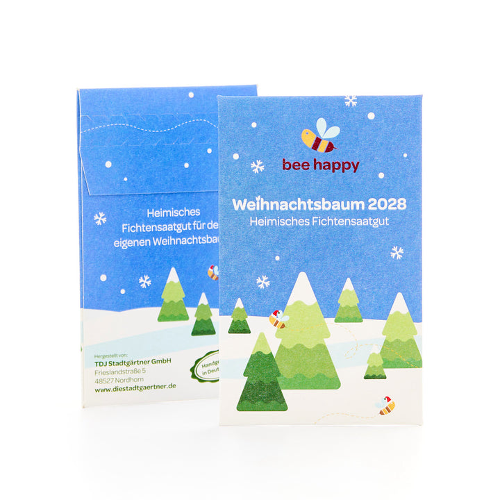 Deux paquets bleus avec un motif de Noël mettant en vedette des sapins, des flocons de neige et une abeille, étiquetés « Christmas Tree 2028 Native Spruce Seed » et le slogan « bee happy ».