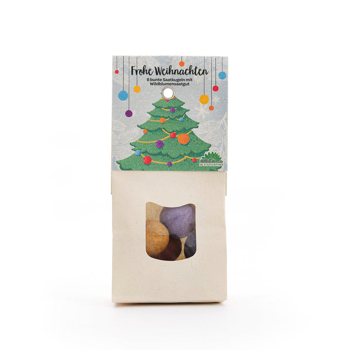 Sachet de boules de graines colorées, emballées dans un style de Noël avec une étiquette représentant un sapin de Noël décoré et les mots « Joyeux Noël ».