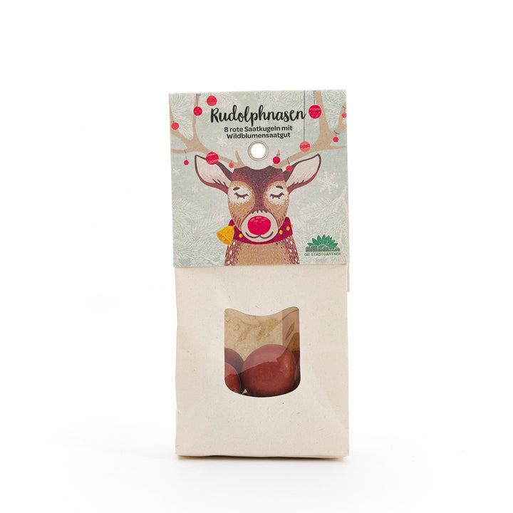 Sac en papier avec un imprimé de renne et le texte « Rudolph Noses – 8 boules de graines rouges avec graines de fleurs sauvages », avec une fenêtre de visualisation contenant des boules de graines rouges en dessous.