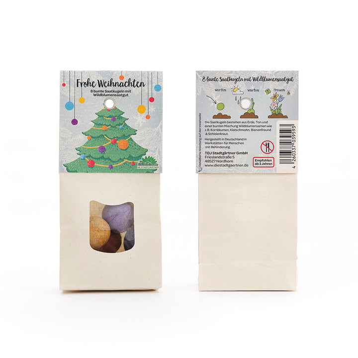 Deux paquets de boules de graines colorées et de graines de fleurs sauvages, avec une illustration d'arbre de Noël et les mots « Joyeux Noël » sur le devant.