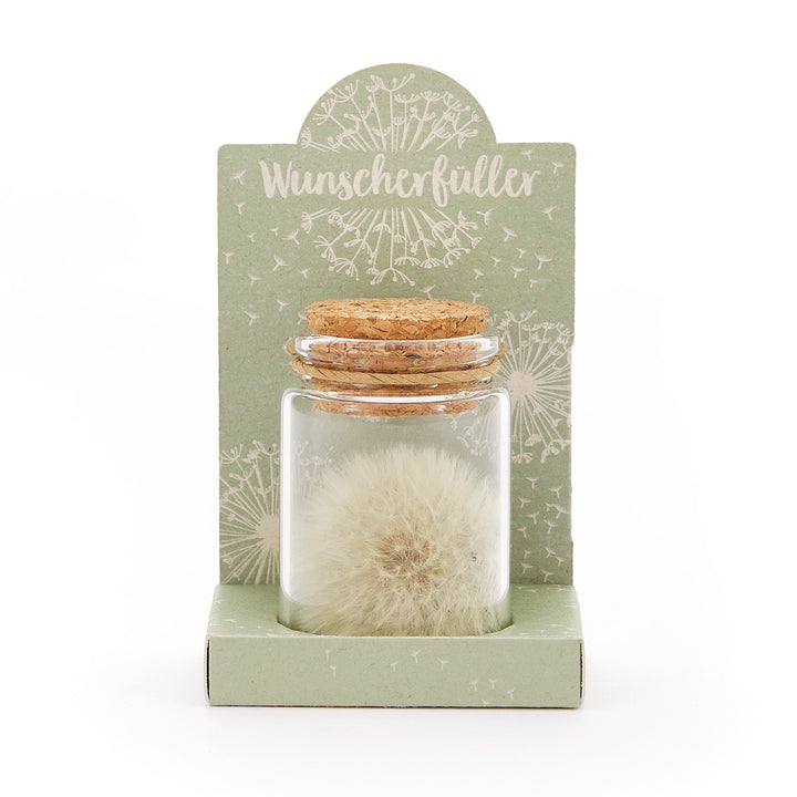 Bouteille en verre avec pissenlit et liège, sur carton vert avec l'inscription "Wish Fulfiller".