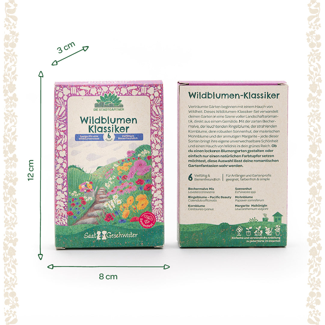 Deux boîtes à graines au design coloré avec l'inscription « Wildflower Classics » de Die Stadtgärtner, y compris des informations sur la taille (12 cm de haut, 8 cm de large, 3 cm de profondeur) et des illustrations de fleurs sur le devant.